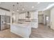 Modern kitchen with white cabinetry, island, and stainless steel appliances at 6403 Ava Ridge Ave, Las Vegas, NV 89141