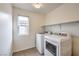 Bright laundry room, features washer, dryer, and built-in shelving at 6403 Ava Ridge Ave, Las Vegas, NV 89141