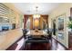 Sunlit dining room with hardwood floors, marble table, and patio access at 6422 Hughes Springs Dr, Las Vegas, NV 89131