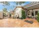 Spacious tiled patio with pergola, seating area, and lush landscaping at 6422 Hughes Springs Dr, Las Vegas, NV 89131