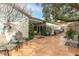 Relaxing patio with seating area, mature trees, and water feature at 6422 Hughes Springs Dr, Las Vegas, NV 89131