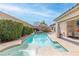 Inviting backyard oasis with a sparkling pool, spa, and covered patio at 6422 Hughes Springs Dr, Las Vegas, NV 89131