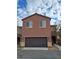 Two-story house with brown exterior and a two-car garage at 690 Calamus Palm Pl, Henderson, NV 89011