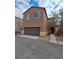 Two-story house with brown exterior and a two-car garage at 690 Calamus Palm Pl, Henderson, NV 89011