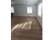 Bright and airy living room with light wood-look flooring at 690 Calamus Palm Pl, Henderson, NV 89011