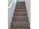 Gray carpeted staircase leading to the upper level at 690 Calamus Palm Pl, Henderson, NV 89011