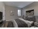 Virtually staged bedroom with a king-size bed and gray bedding at 6955 N Durango Dr # 1048, Las Vegas, NV 89149