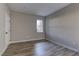 Bright bedroom with wood-look flooring and a window at 6955 N Durango Dr # 1048, Las Vegas, NV 89149