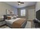 Virtually staged main bedroom with a king-size bed and neutral decor at 6955 N Durango Dr # 1048, Las Vegas, NV 89149