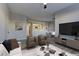 Virtually staged living room features hardwood floors and a view into the kitchen at 6955 N Durango Dr # 1048, Las Vegas, NV 89149