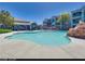 Community swimming pool with a rock waterfall feature at 6955 N Durango Dr # 1048, Las Vegas, NV 89149