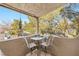 Small balcony with table and chairs, offering a treetop view at 700 Capri Dr # 34C, Boulder City, NV 89005