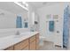 Clean bathroom with a white vanity, tile flooring, and a shower/tub combo at 700 Capri Dr # 34C, Boulder City, NV 89005