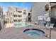 Community pool and spa area with lounge chairs at 700 Capri Dr # 34C, Boulder City, NV 89005