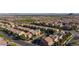 An aerial view showcases rows of homes, green spaces, and mountains in the distance at 7129 Flora Lam St, Las Vegas, NV 89166