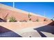 This backyard showcases desert landscaping, with a raised planter bed and a circular paved area at 7129 Flora Lam St, Las Vegas, NV 89166