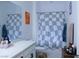 Clean bathroom with checkered shower curtain and updated vanity at 7129 Flora Lam St, Las Vegas, NV 89166