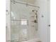 Bathroom with clear glass shower stall and brushed nickel hardware at 7129 Flora Lam St, Las Vegas, NV 89166