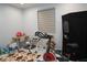 This bedroom is currently used as a playroom, featuring a stationary bike and a large window at 7129 Flora Lam St, Las Vegas, NV 89166