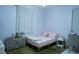 Charming bedroom with pastel decor, soft lighting, and window views at 7129 Flora Lam St, Las Vegas, NV 89166