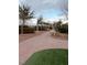 Brick pathway winds through landscaped community gardens with archways at 7129 Flora Lam St, Las Vegas, NV 89166