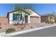 Front view of a single-story house with a two-car garage at 7129 Flora Lam St, Las Vegas, NV 89166