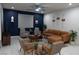 Spacious living room featuring a stylish leather sectional sofa and accent chairs at 7129 Flora Lam St, Las Vegas, NV 89166