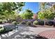 Scenic park view featuring a metal bench, lush trees, and well-maintained shrubs, providing a relaxing atmosphere at 7129 Flora Lam St, Las Vegas, NV 89166