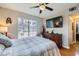 Bright bedroom featuring wood floors, a large TV, and ample closet space at 7173 S Durango Dr # 212, Las Vegas, NV 89113