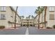 Exterior view of a two-story building with palm trees and garages at 7173 S Durango Dr # 212, Las Vegas, NV 89113