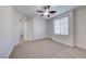 Bright bedroom with carpet flooring, double doors, and a ceiling fan at 7683 Jasmine Falls Dr, Las Vegas, NV 89179