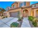 Two story house with a two car garage and landscaped front yard at 7683 Jasmine Falls Dr, Las Vegas, NV 89179