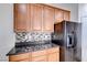 Kitchen with black appliances and granite countertops at 7683 Jasmine Falls Dr, Las Vegas, NV 89179