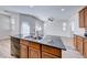 Kitchen island with double sink and views into Gathering room at 7683 Jasmine Falls Dr, Las Vegas, NV 89179