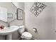 Small bathroom with pedestal sink and decorative wall art at 7879 Narnia Ave, Las Vegas, NV 89113