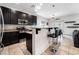 Eat-in kitchen with island, stainless steel appliances, and stylish lighting at 7879 Narnia Ave, Las Vegas, NV 89113