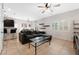 Open living room with sectional sofa and a view of the kitchen at 7879 Narnia Ave, Las Vegas, NV 89113