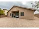 Tan house exterior, covered patio and gravel backyard at 7976 Sleeping Lily Dr, Las Vegas, NV 89178