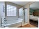 Bathroom with soaking tub, shower, and tile flooring at 7976 Sleeping Lily Dr, Las Vegas, NV 89178