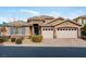 Single-story house with a three-car garage and landscaped front yard at 7976 Sleeping Lily Dr, Las Vegas, NV 89178