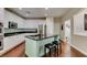 Bright kitchen with white cabinets, granite island, and stainless steel appliances at 7976 Sleeping Lily Dr, Las Vegas, NV 89178