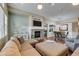 Beach-themed living room with sectional sofa and stone fireplace at 7976 Sleeping Lily Dr, Las Vegas, NV 89178