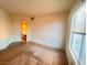 View of a vacant bedroom with large window, carpeted floors and open closet at 8070 W Russell Rd # 2068, Las Vegas, NV 89113