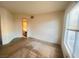 Empty bedroom with carpet, large window, and door to hallway at 8070 W Russell Rd # 2068, Las Vegas, NV 89113