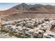 Aerial view of modern homes and desert landscape with mountain backdrop at 816 Loch Katrine Ave, Henderson, NV 89012