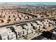 Aerial view of modern homes, neighborhood, and distant city skyline at 816 Loch Katrine Ave, Henderson, NV 89012