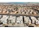 Aerial view of modern homes with mountain and city views in the distance at 816 Loch Katrine Ave, Henderson, NV 89012