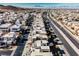 Aerial view of modern homes with a main road and distant mountains at 816 Loch Katrine Ave, Henderson, NV 89012