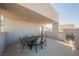 Covered balcony with dining table and fireplace at 816 Loch Katrine Ave, Henderson, NV 89012