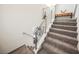 Modern staircase with gray carpeting and metal railings at 816 Loch Katrine Ave, Henderson, NV 89012